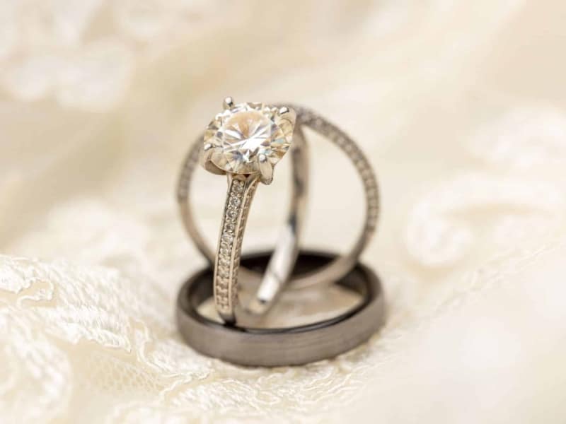rings-sitting-on-top-of-wedding-dress