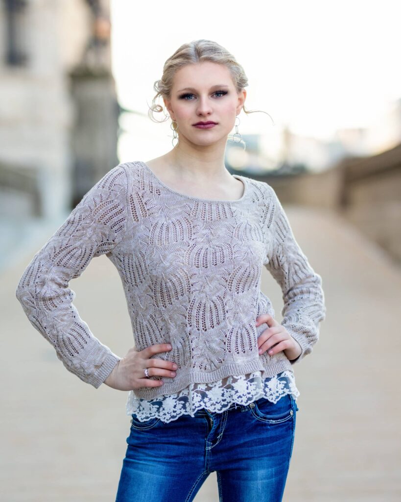 Amber exudes confidence and style during her senior picture session. Sporting a trendy pair of jeans and a fashionable top, she effortlessly showcases her individuality and personality.