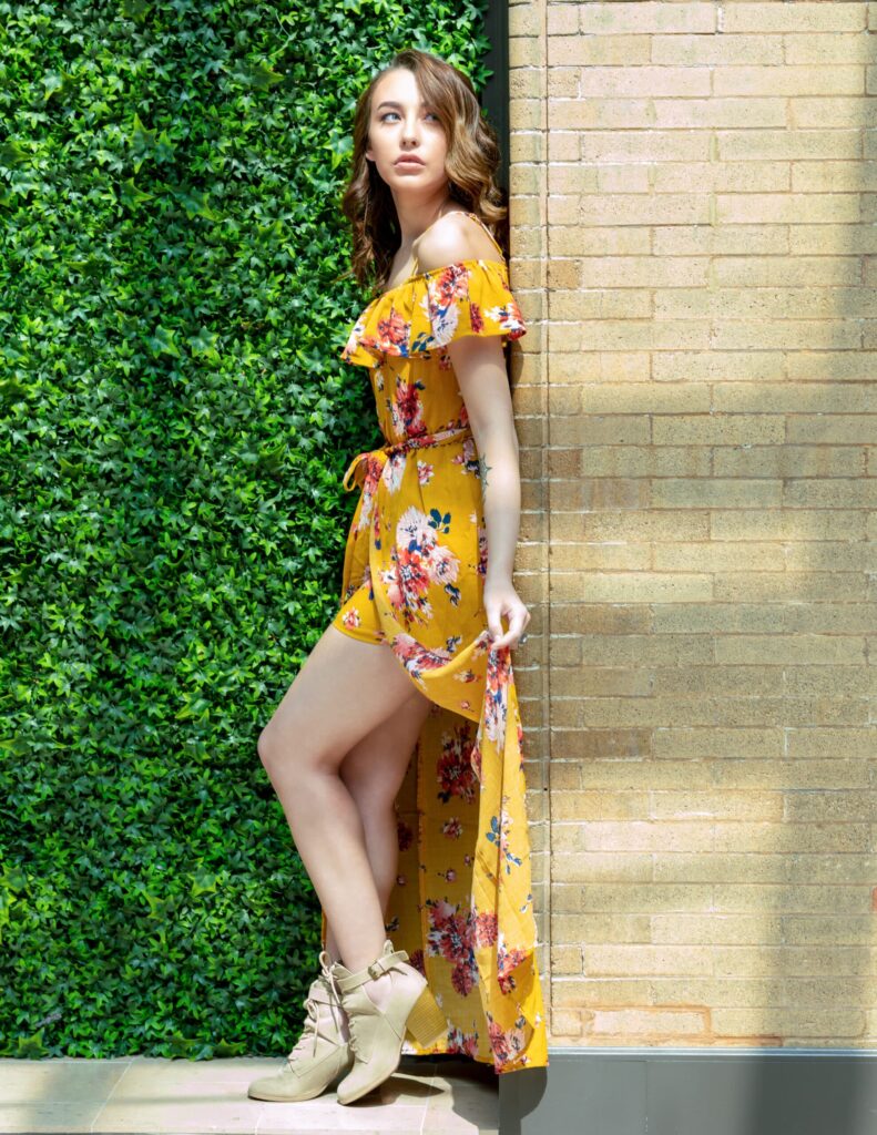 Sophia in a vibrant yellow floral dress